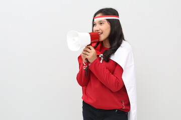 Indonesian woman celebrating Indonesian Independence Day, shouting using megaphone facing sideways...
