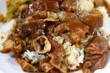 Thai stewed pork intestines braised with aromatic spices served over fluffy rice, authentic street food dish representing rich flavors of Asian culinary culture.