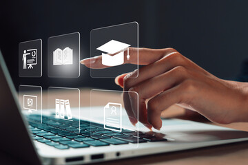 hand touching virtual education icons on laptop, symbolizing online learning, digital education, remote training, virtual classroom, e-learning platform, and academic development.