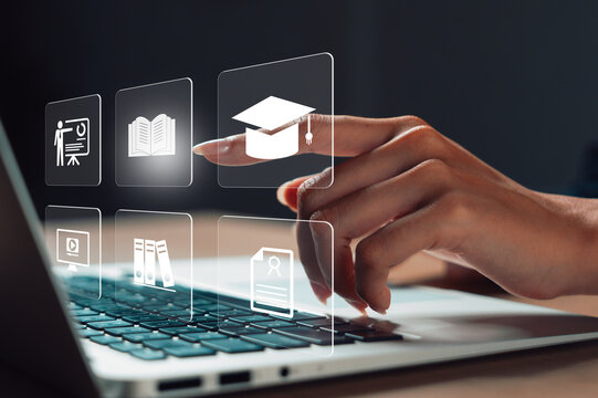 hand touching virtual education icons on laptop, symbolizing online learning, digital education, remote training, virtual classroom, e-learning platform, and academic development.