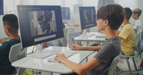 Obraz premium Smart Young Boy Using Computer, Creating Digital Illustration in AI Image Generator. Elementary School Children Learning Artificial Intelligence During Digital Art Lesson. STEM Education. Static Shot.