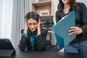 In a tense office scene, an overwhelmed employee faces immense pressure and stress at work