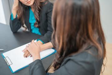 Two women engage in a focused and strategic business discussion during a meeting