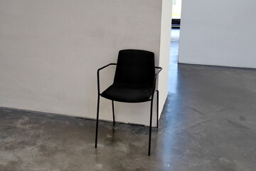 Chaise de gardien de musée dans une salle blanche.