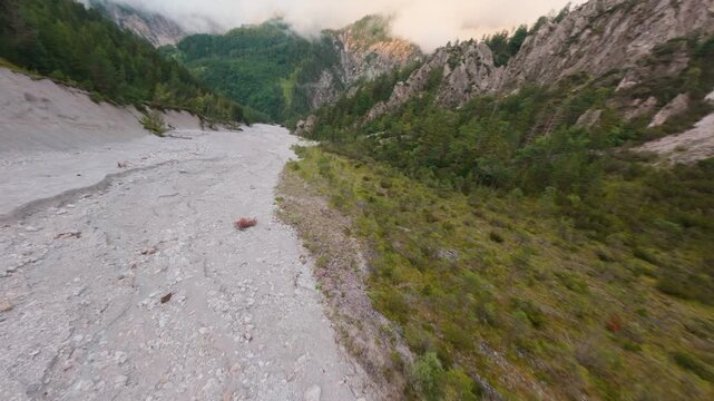 Empty riverbed in Austrian Alps caused by climate change, aerial perspective