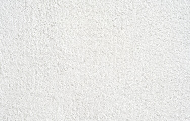 Close-up of textured white carpet surface with detailed fabric weave pattern.