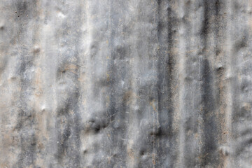 Weathered beaten aluminum surface with dents and scratches outdoors