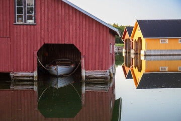 Beautiful view of wooden boat sheds on the water of the Baltic Sea in a cozy fishing Finnish...