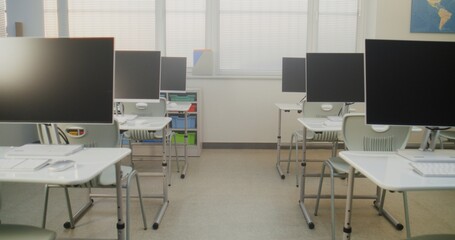 High-Tech School Computer Lab with Minimalist Furniture and PC Monitors. Modern Classroom Setup Ready for Students to Practice Coding, Design, STEM Projects and Innovative Digital Learning. Dolly Shot
