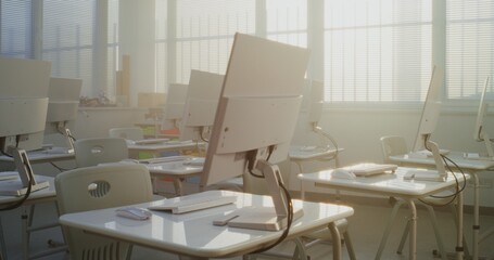 Modern Educational Space with Computer Desks, White Monitors. Computer Science Classroom Prepared for Interactive Learning, Digital Skills Training and Technology-Based School Activities. Dolly Shot.