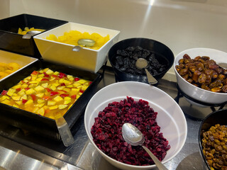 Breakfast buffet with healthy sweet toppings like stewed fruits, raisins, nuts, and compotes....