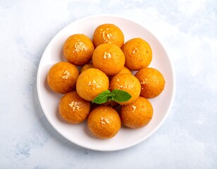 Round, light orange treats on a white plate