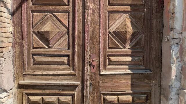 This is the entrance to an old house, and the doors here need repair because they've fallen into disrepair over the years."