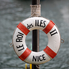 NICE, FRANCE - MAY 28, 2018: Lifebuoy on boat in the Port de Nice harbour with name