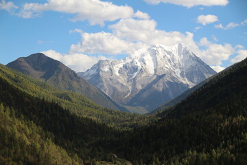 Majestic snow-capped mountain peaks pierce a clear blue sky Yala Snow Mountain Sichuan, China