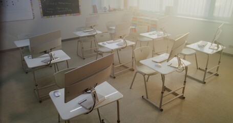 High-Tech School Computer Lab with Desks and PC Monitors. Modern Classroom Setup Ready for Students to Practice Coding, Design, STEM Projects and Innovative Digital Learning. High Angle. Dolly Shot.