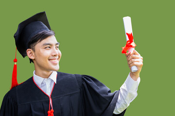 Portrait of happy male graduate student in black robes and hats finished their education, holding a...