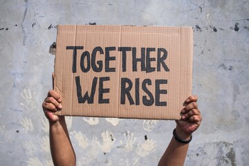 Hands Holding Protest Signs with Words 