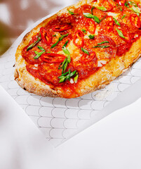 Delicious flatbread topped with spicy tomato sauce and fresh herbs