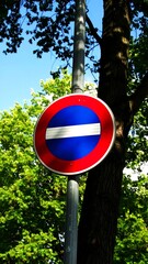 Round traffic sign against a blue sky