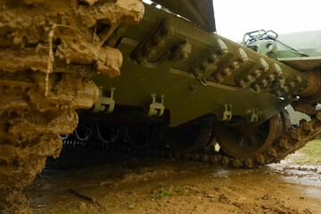 T-72 tank tracks testing in muddy weather at proving ground.
