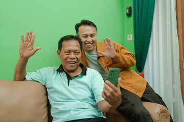 Two family members happily engaging in a video call, showcasing modern connection.