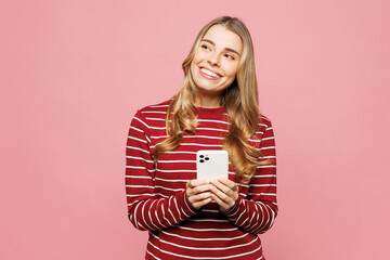 Young happy woman wearing red striped sweatshirt casual clothes hold in hand use mobile cell phone...