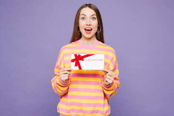 Young shocked surprised woman she wears yellow sweatshirt casual clothes hold gift certificate...