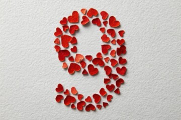 number nine made of papery tiny Christmas elimant on white background
