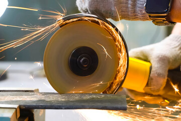 Grinding throwing knife in a vise using an angle grinder.