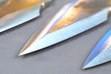 Sharpened and polished homemade throwing knives making cold weapons.