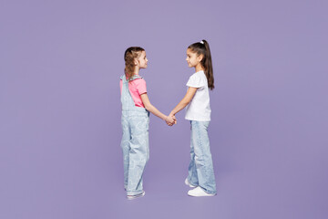 Full body side profile view little two friends kids children girls 9-10 years old wearing casual...
