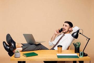 Full body young happy employee business man wears white shirt tie sit work at office desk with pc...