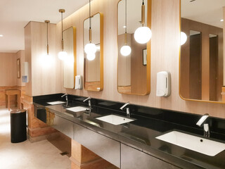 Contemporary commercial restroom design with sleek fixtures and a focus on hygiene and aesthetics