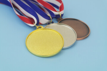Gold, silver and bronze medals with ribbons close up