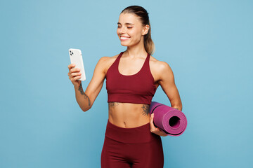 Young fitness trainer instructor sporty woman sportsman wear red sportswear training in home gym...