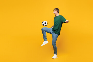 Full body sideways young happy man fan wear basic green t-shirt cheer up support football sport...