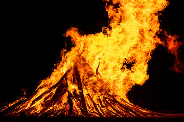 Large bonfire burning at night for summer solstice
