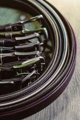 This closeup image showcases an intricate arrangement of circular belts and clips, inspiring...