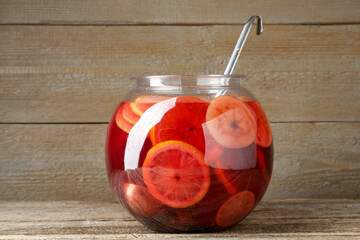 Tasty fruity punch on wooden table. Refreshing drink