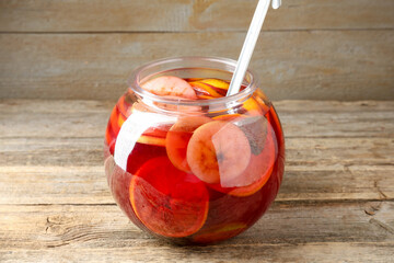 Tasty fruity punch on wooden table. Refreshing drink