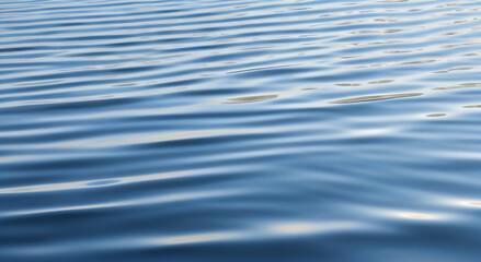 Naklejka premium Rippled Blue Water Surface with Sunlight Reflections