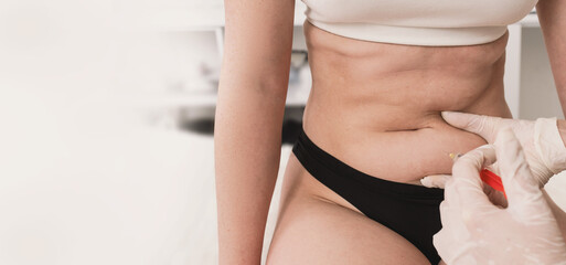 Injections of lipolytic into abdomen for weight loss and muscle definition in office of...