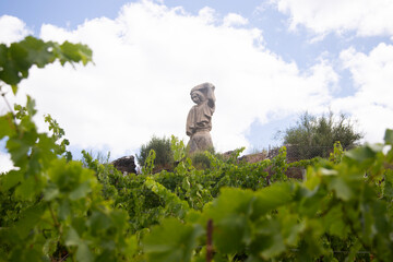 Statue of a woman harvesting grapes in vineyards on the slopes of the Sil Canyon in the Ribiera...