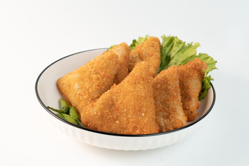 Close up Risol Mayo segitiga or Triangle Risol mayonnaise served in a white bowl with fresh lettuce and green chili on white background. Showcasing a savory Indonesian snack with breadcrumb coating