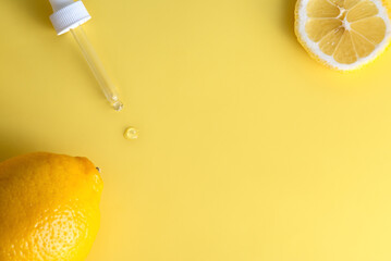 Fresh lemon extract with pipette and a drop of essence, copy space.