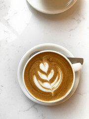 Cappuccino with Latte Art on Cafe Table.