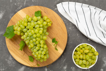 Fresh green grape on concrete background, top view