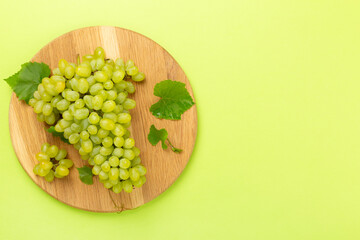 Fresh green grape on color background, top view