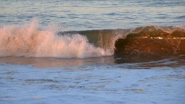 Wave breaking at sunset on the coast of Bethany Beach, Delaware. Slow motion.